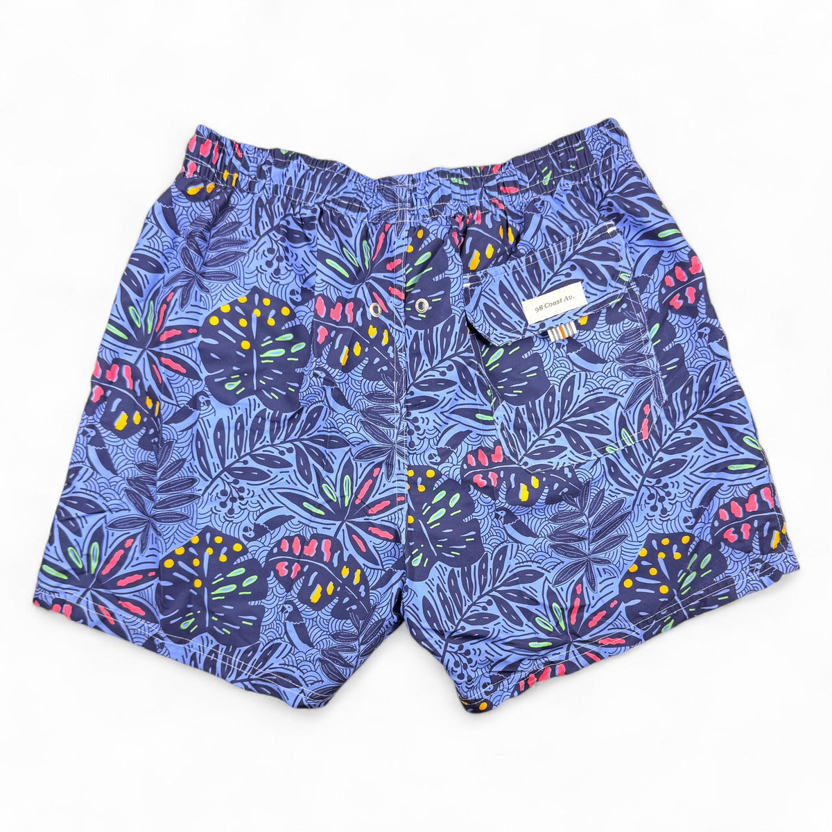 98 Coast Ave men's swim shorts in deep blue with a multicolored tropical leaf print and white drawstring waist, back pocket detail, back view