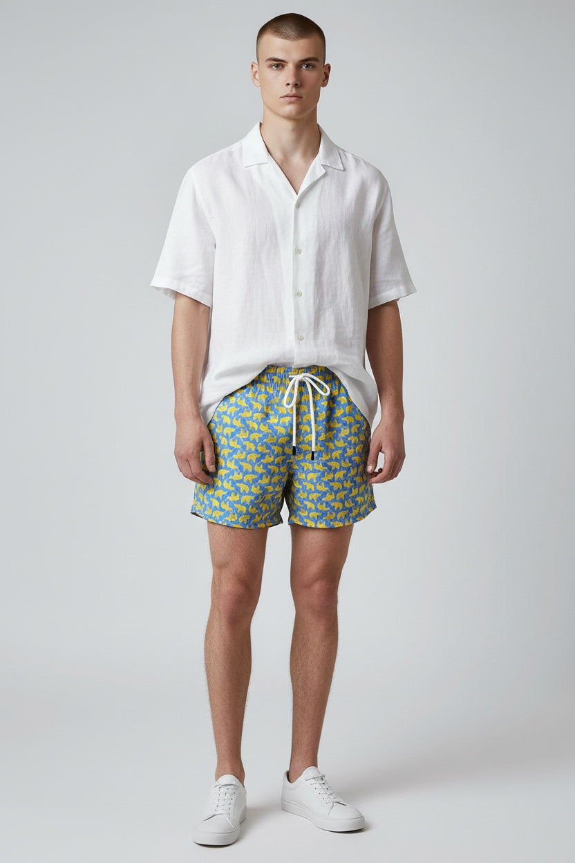 98 Coast men's blue elephant print swim shorts styled with a casual whit shirt for a casual resort look.