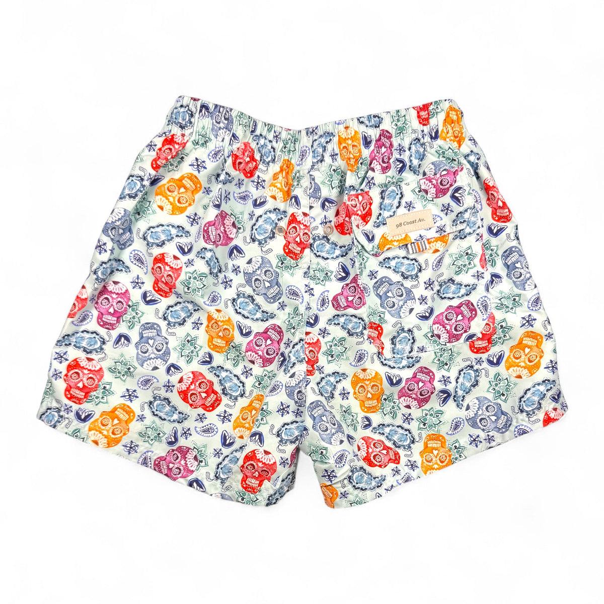 98 Coast Av. Men's swim shorts featuring vibrant multicolor sugar skull print on a light background with a drawstring, back pocket detail, back view