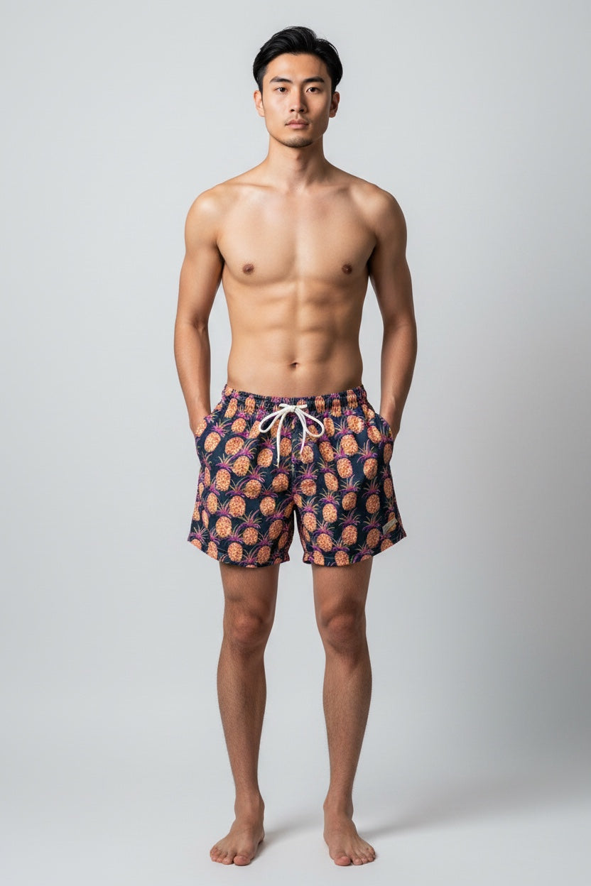 98 Coast Av. men's navy blue swim shorts with tropical pineapple print, elastic waistband and white drawstring, model, front view