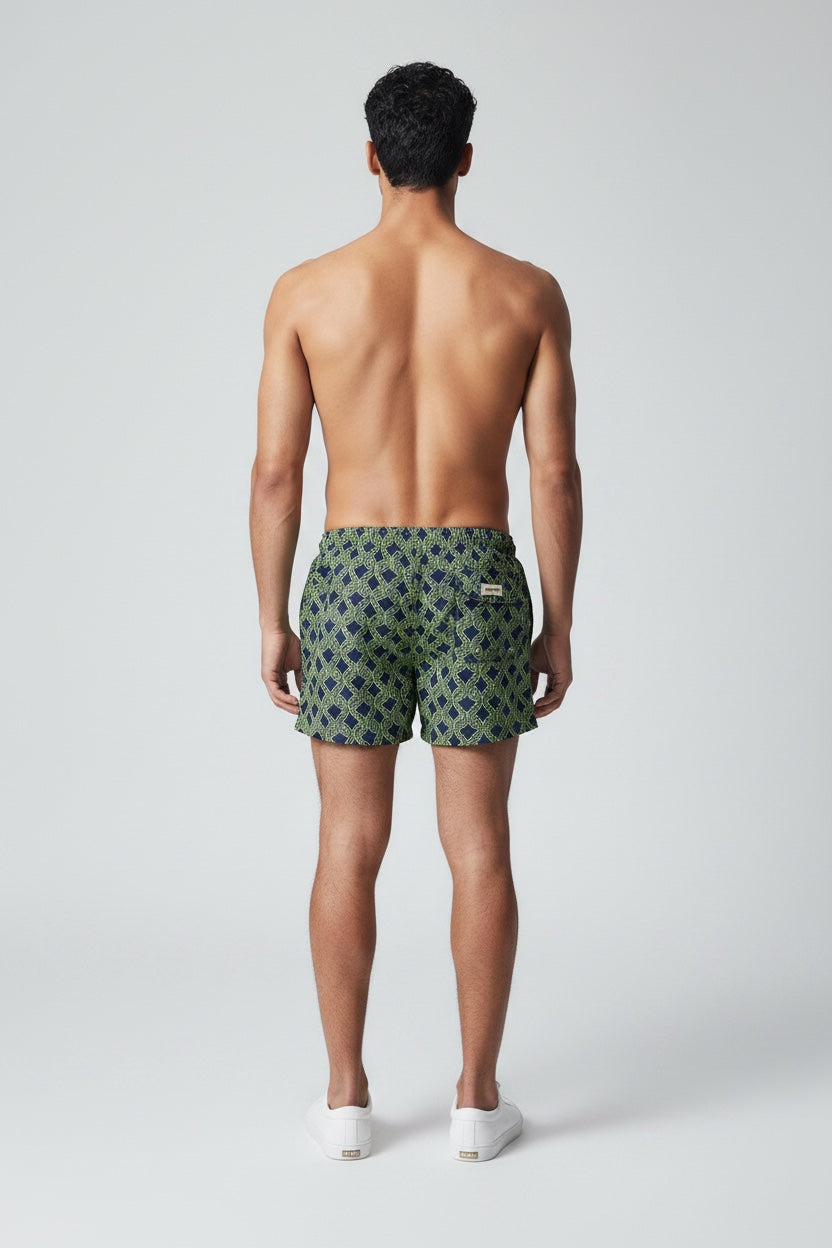 98 Coast men's navy blue swim shorts with a lime green nautical rope print, elastic waistband, pocket detail, model, back view